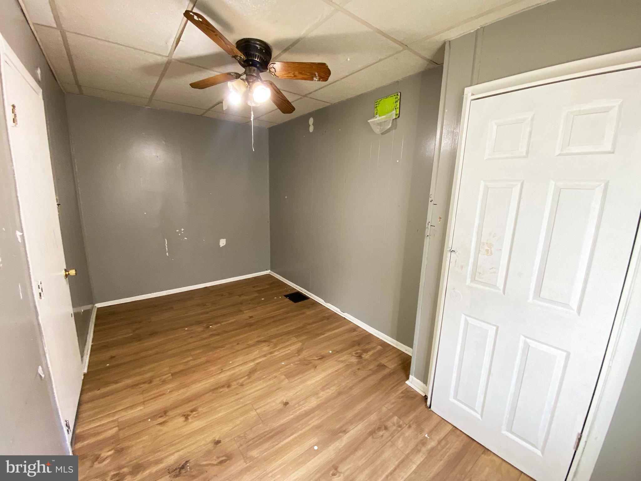 3342 Malta Street Philadelphia, PA 19134 - Photo 29 of 39 an empty room with wooden floor and fan