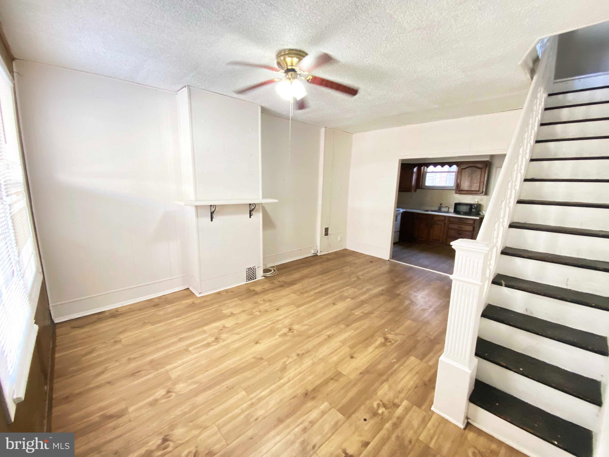 3342 Malta Street Philadelphia, PA 19134 - Photo 9 of 39 a view of a livingroom with wooden floor and a ceiling fan