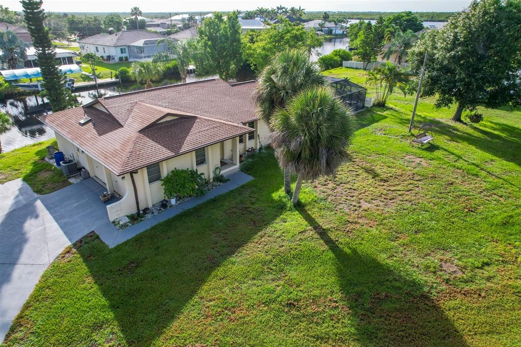 an aerial view of residential houses with outdoor space and street view