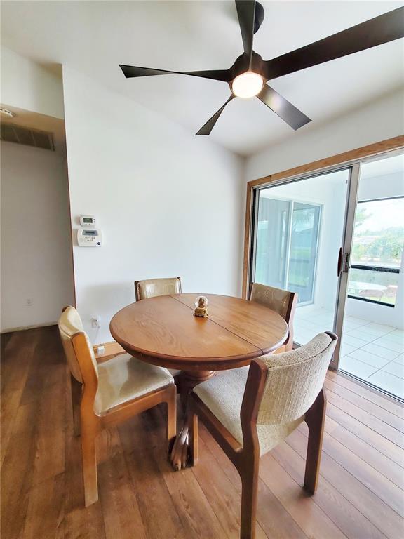 3456 Highlands Road Punta Gorda, FL 33983 - Photo 12 of 80 a view of a dining room with furniture and wooden floor