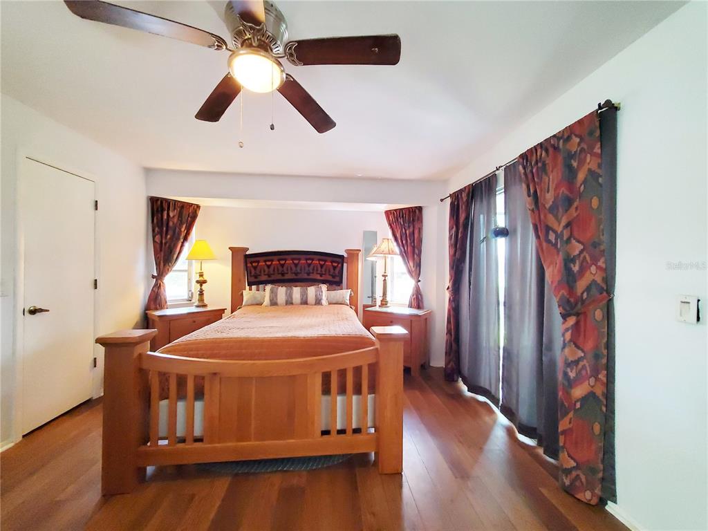 3456 Highlands Road Punta Gorda, FL 33983 - Photo 15 of 80 a bedroom with a bed and wooden floor