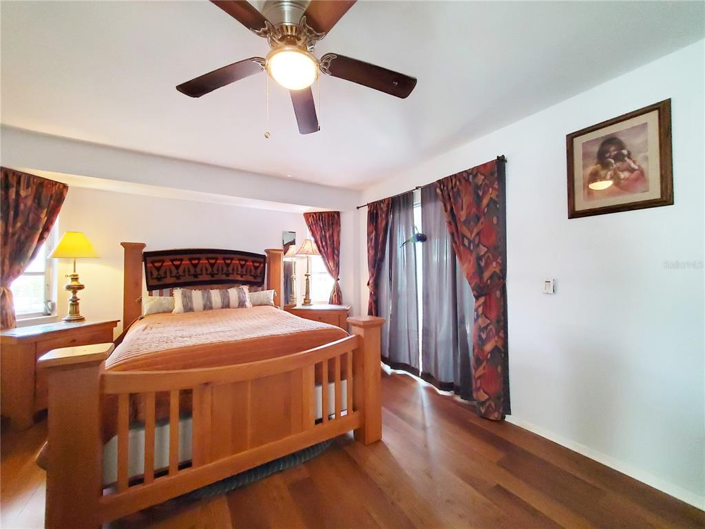 3456 Highlands Road Punta Gorda, FL 33983 - Photo 16 of 80 a bedroom with a bed and a chandelier