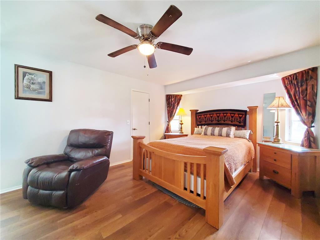 3456 Highlands Road Punta Gorda, FL 33983 - Photo 17 of 80 a bedroom with a bed and wooden floor