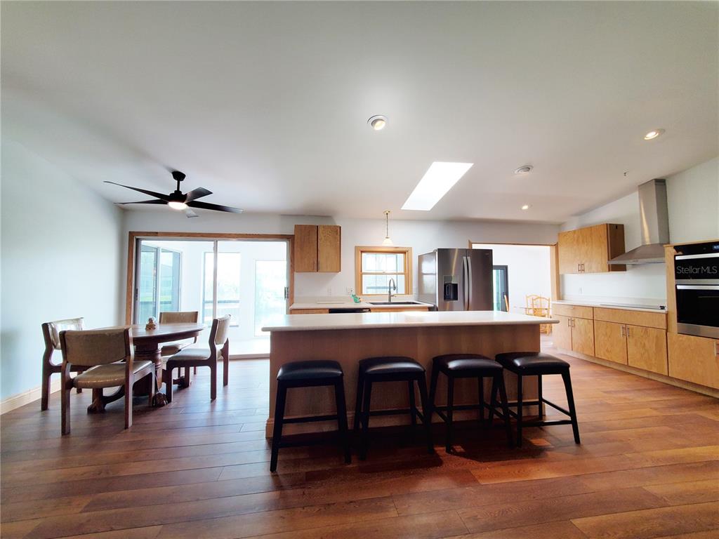 3456 Highlands Road Punta Gorda, FL 33983 - Photo 25 of 80 a view of a dining room with furniture window and wooden floor