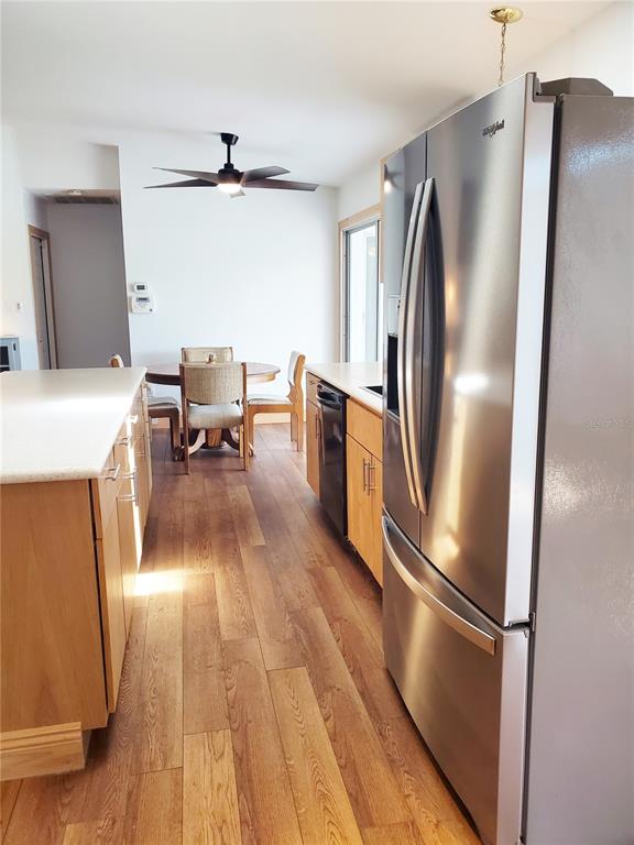 3456 Highlands Road Punta Gorda, FL 33983 - Photo 26 of 80 a kitchen with stainless steel appliances a refrigerator microwave and stove with wooden floor