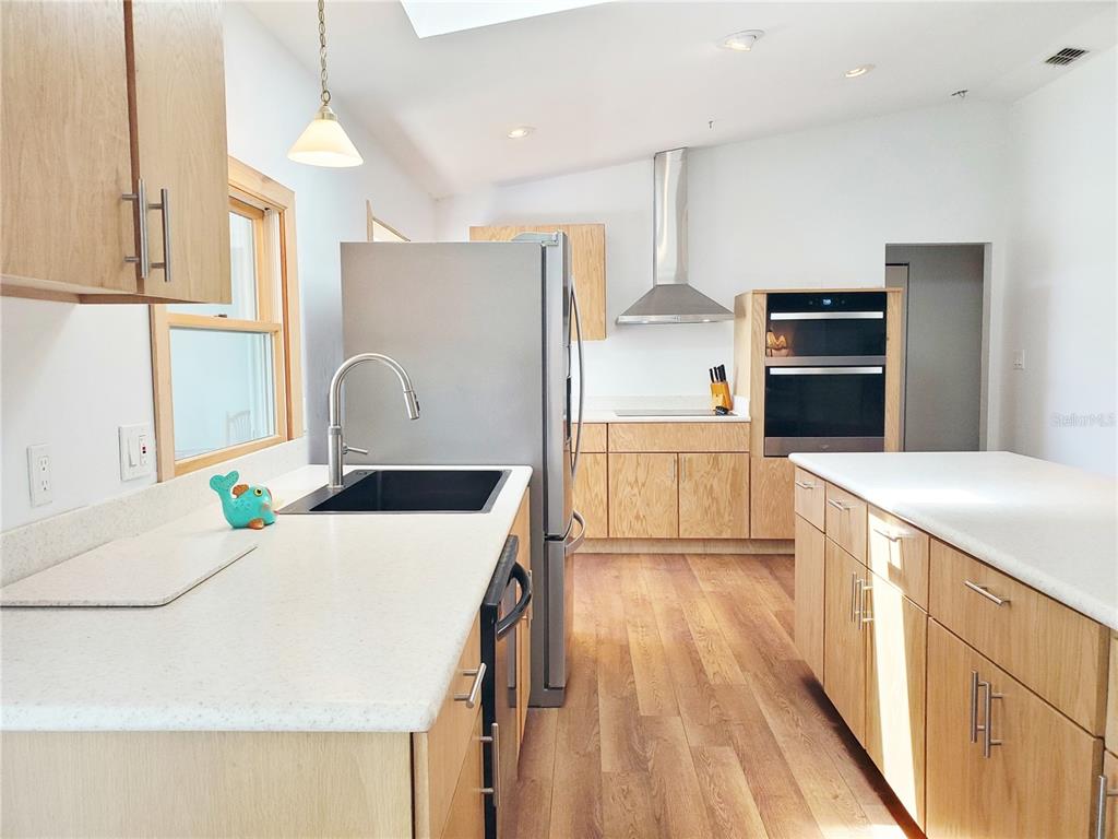 3456 Highlands Road Punta Gorda, FL 33983 - Photo 28 of 80 a kitchen with kitchen island a counter top space appliances and cabinets
