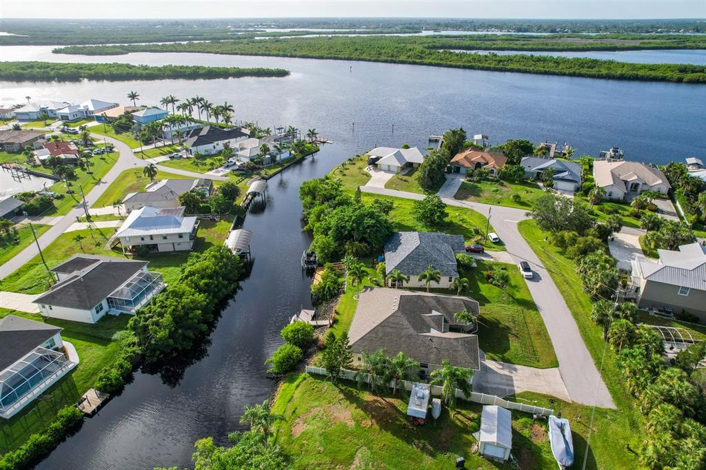 3456 Highlands Road Punta Gorda, FL 33983 - Photo 3 of 80 an aerial view of lake and residential houses with outdoor space and swimming pool