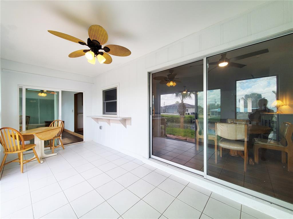 3456 Highlands Road Punta Gorda, FL 33983 - Photo 36 of 80 a living room with furniture and a floor to ceiling window