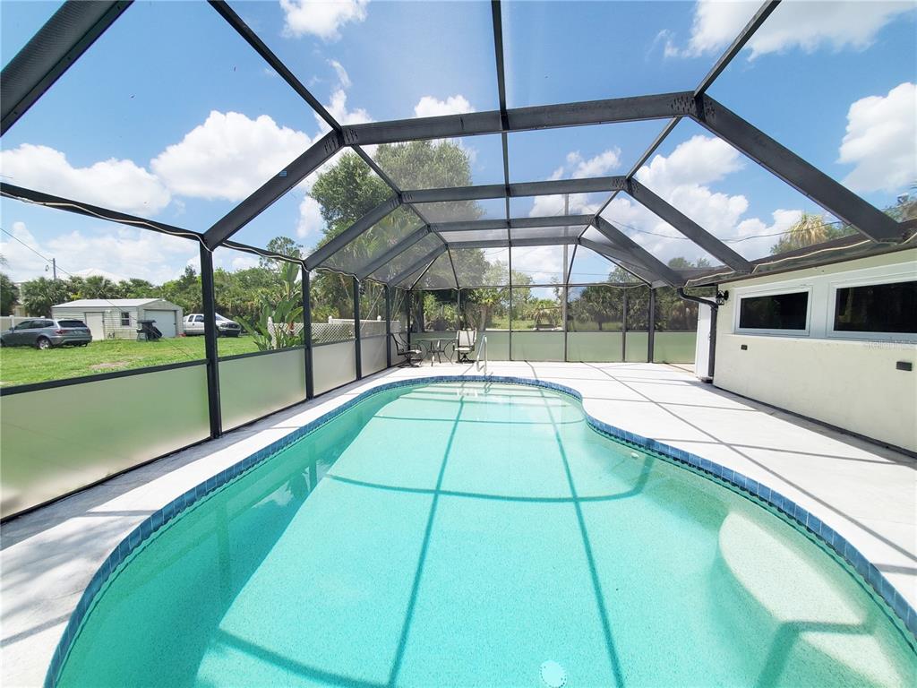 3456 Highlands Road Punta Gorda, FL 33983 - Photo 54 of 80 a swimming pool with a yard