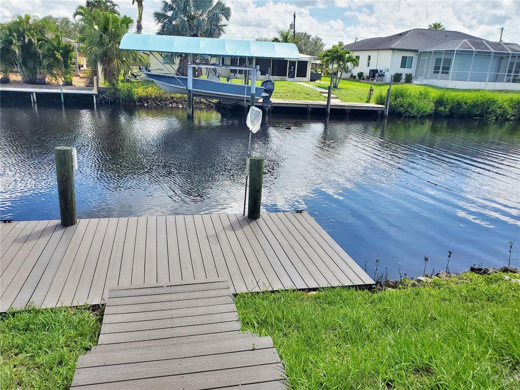 3456 Highlands Road Punta Gorda, FL 33983 - Photo 64 of 80 a view of swimming pool with lawn chairs and plants