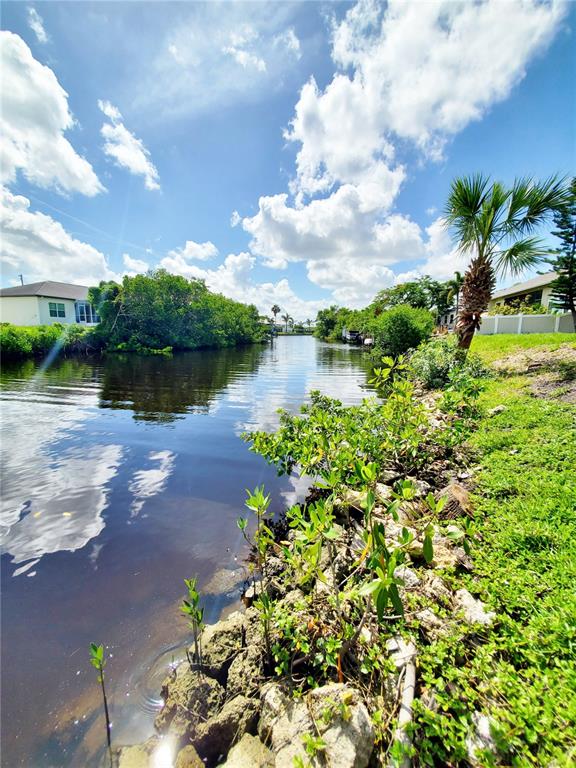 3456 Highlands Road Punta Gorda, FL 33983 - Photo 68 of 80 a view of a lake with a building in the background