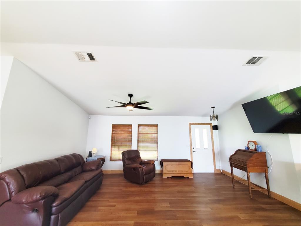 3456 Highlands Road Punta Gorda, FL 33983 - Photo 7 of 80 a living room with furniture and a flat screen tv
