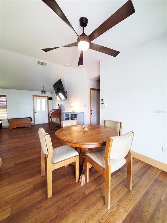 3456 Highlands Road Punta Gorda, FL 33983 - Photo 10 of 80 a view of a dining room with furniture and wooden floor
