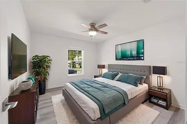 a bedroom with a bed and a flat screen tv