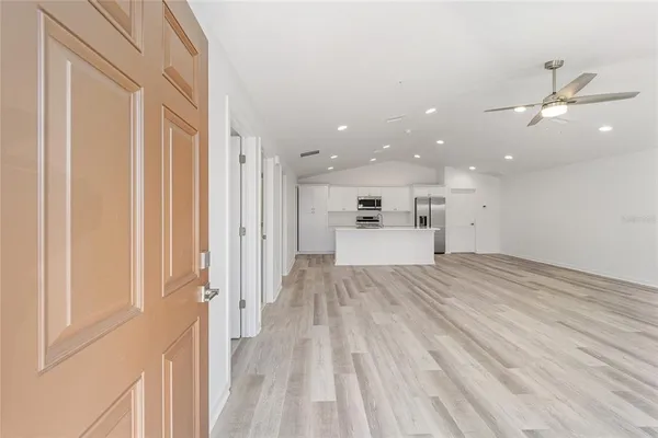 a view of a kitchen with a sink and a refrigerator