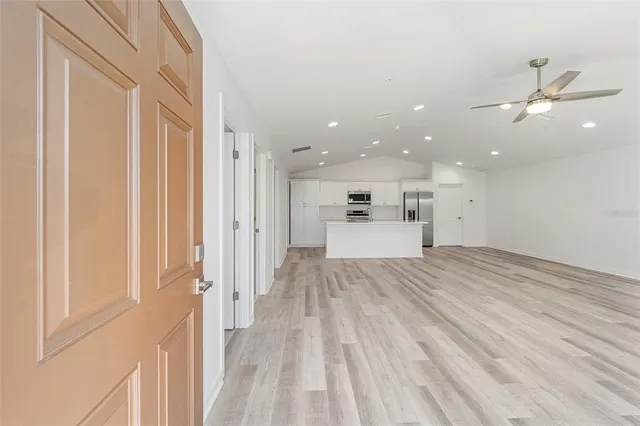 a view of a kitchen with a sink and a refrigerator