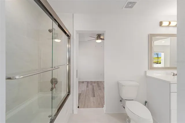 a bathroom with a toilet and a shower