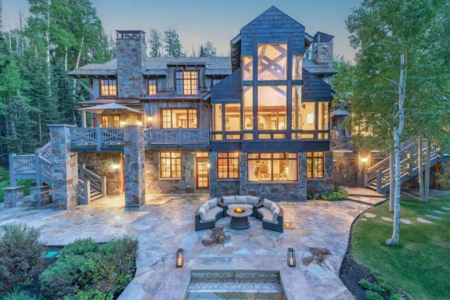 a front view of a building with balcony and outdoor seating