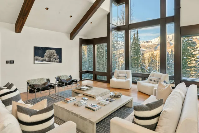 a kitchen with stainless steel appliances a dining table chairs and a refrigerator