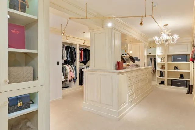 a bedroom with a large bed and a lamp on table