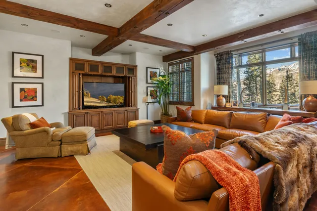 a living room with furniture a rug and a window
