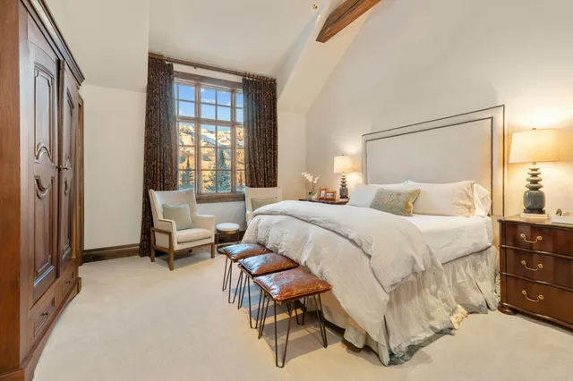 a bedroom with a bed and a potted plant