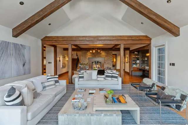 a living room with furniture a chandelier and a chandelier