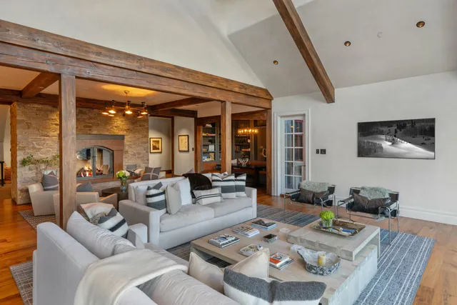 a living room with furniture and a chandelier