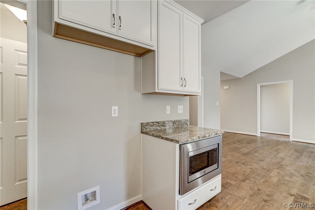 7113 Appleman Road Chesterfield, VA 23832 - Photo 11 of 22 a kitchen with granite countertop white cabinets and white appliances