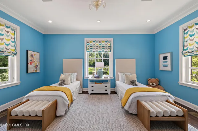 a bed room with two beds and a window