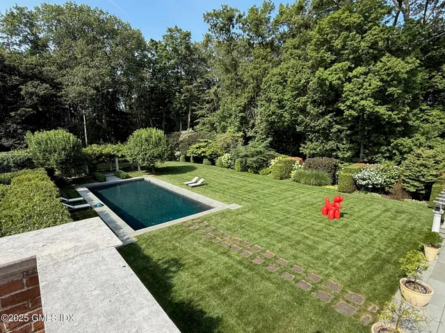 a view of a backyard with a garden and entertaining space