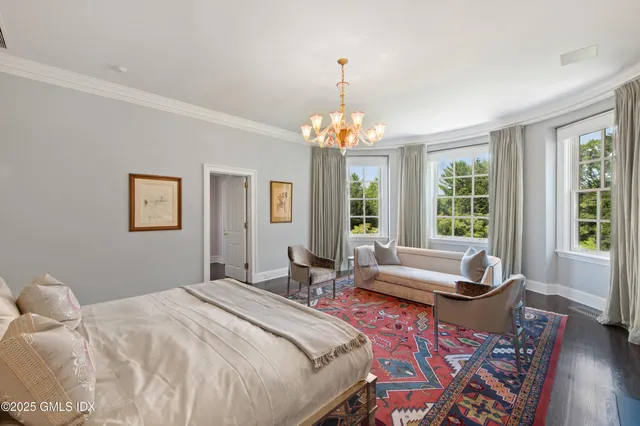 a bedroom with a bed and windows