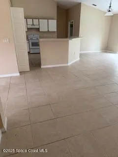 a view of a refrigerator and an empty room