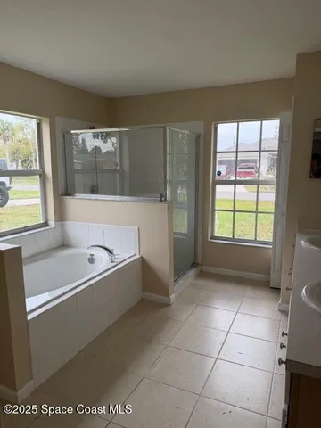 a bathroom with a bathtub and window