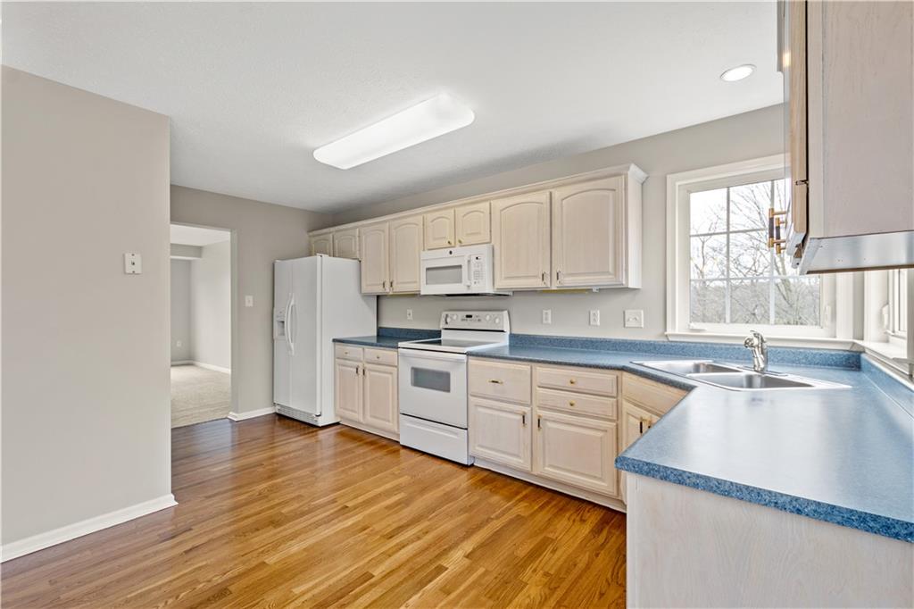 81501 Lost Valley Drive Mars, PA 16046 - Photo 14 of 25 a kitchen with white cabinets and wooden floor