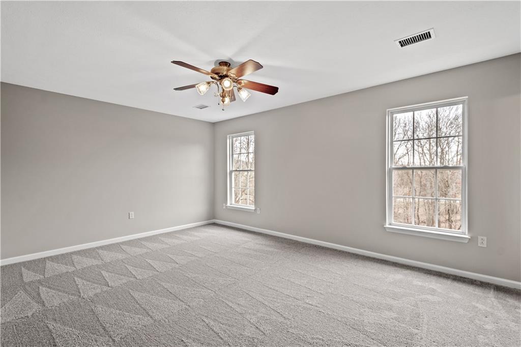 81501 Lost Valley Drive Mars, PA 16046 - Photo 19 of 25 an empty room with windows and chandelier fan