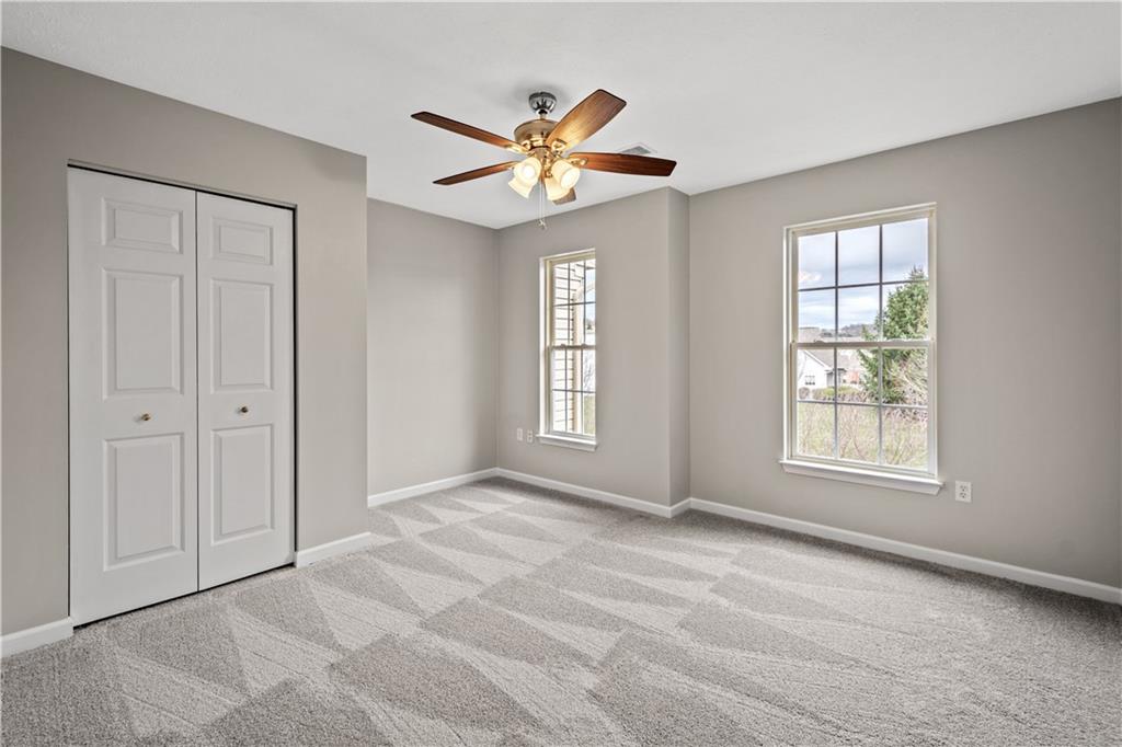 81501 Lost Valley Drive Mars, PA 16046 - Photo 24 of 25 a view of an empty room with window and chandelier fan