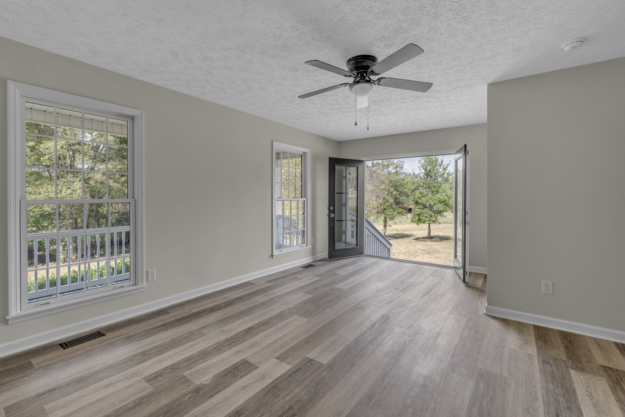 6041 Henry Gower Road Pleasant View, TN 37146 - Photo 15 of 63 a view of an empty room with wooden floor and a window