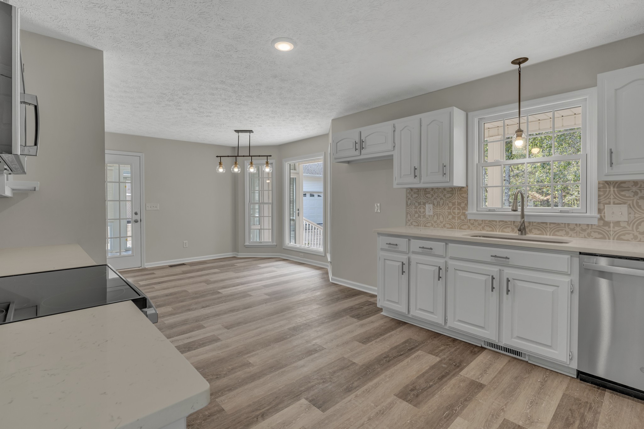 6041 Henry Gower Road Pleasant View, TN 37146 - Photo 18 of 63 a hall with kitchen island white cabinets and wooden floor