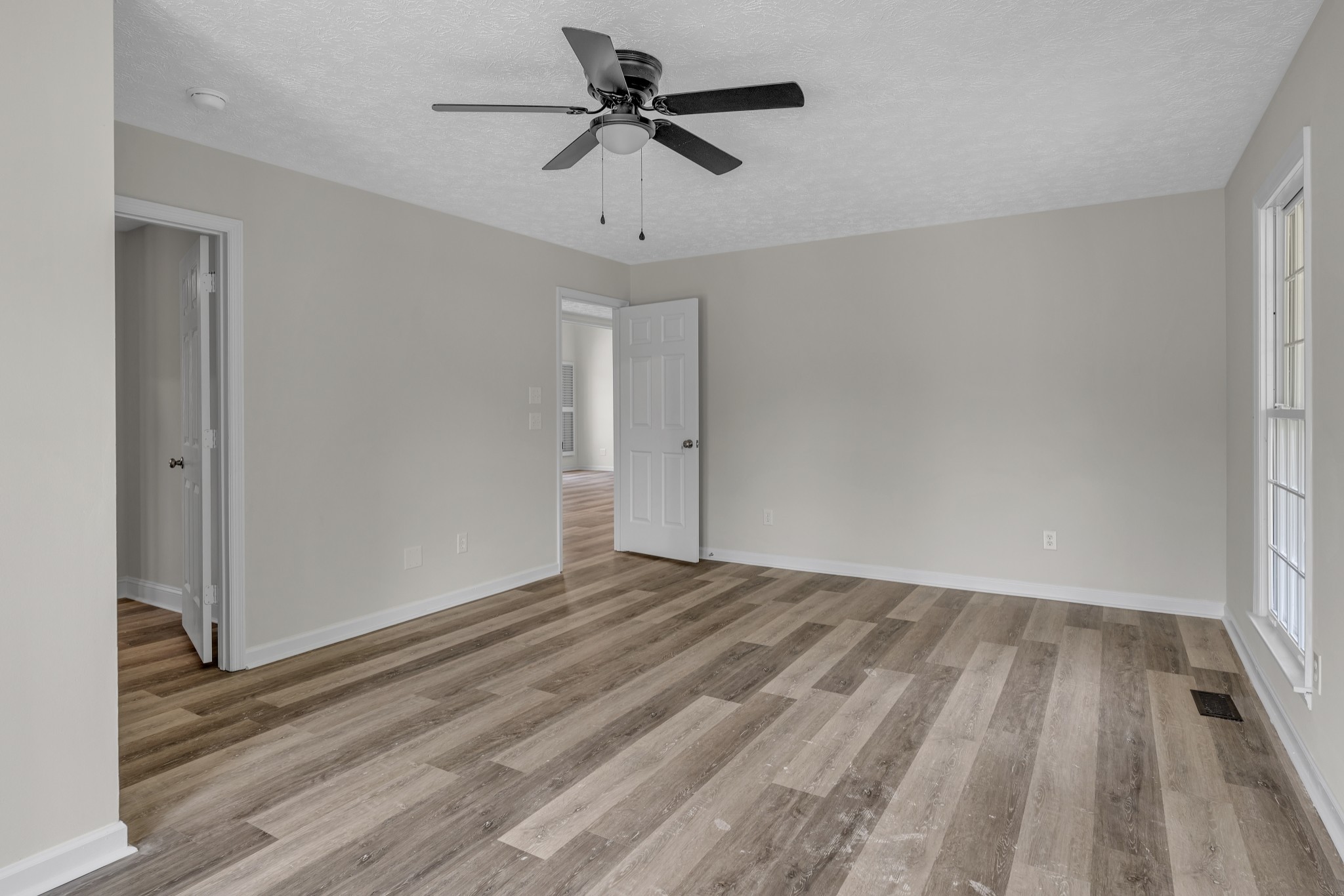 6041 Henry Gower Road Pleasant View, TN 37146 - Photo 38 of 63 a view of empty room with wooden floor and fan