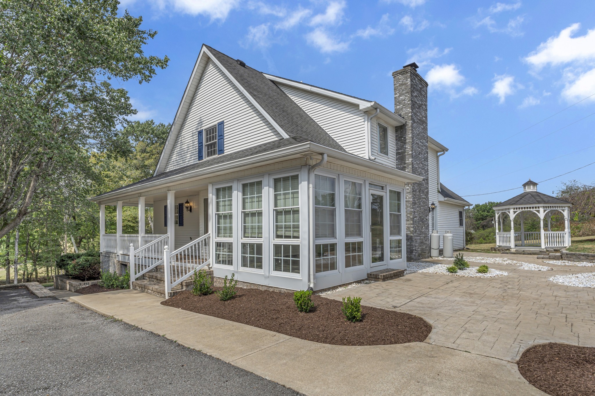 6041 Henry Gower Road Pleasant View, TN 37146 - Photo 46 of 63 a front view of a house with a garden and plants