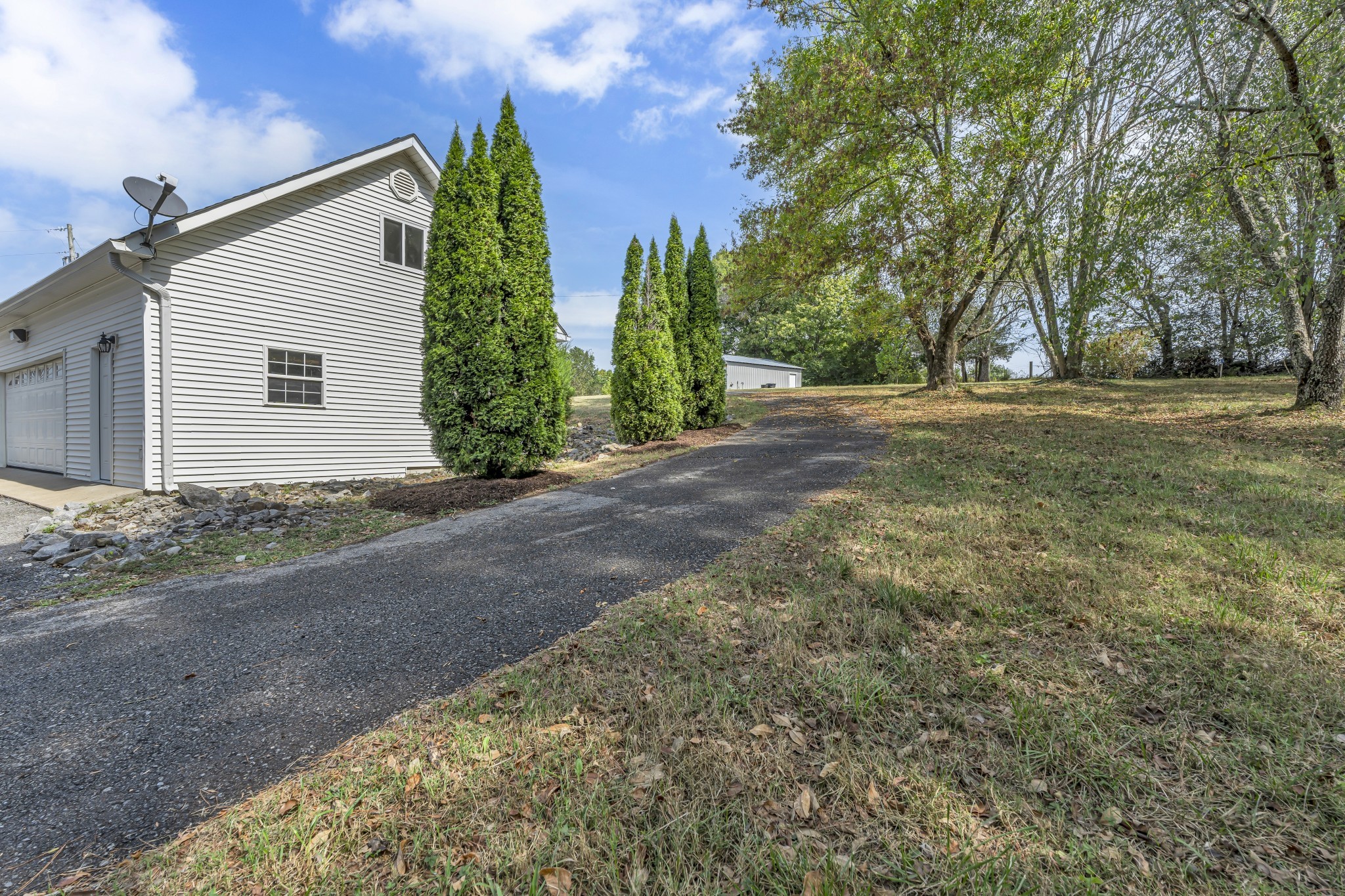 6041 Henry Gower Road Pleasant View, TN 37146 - Photo 55 of 63 a view of a house with backyard and trees
