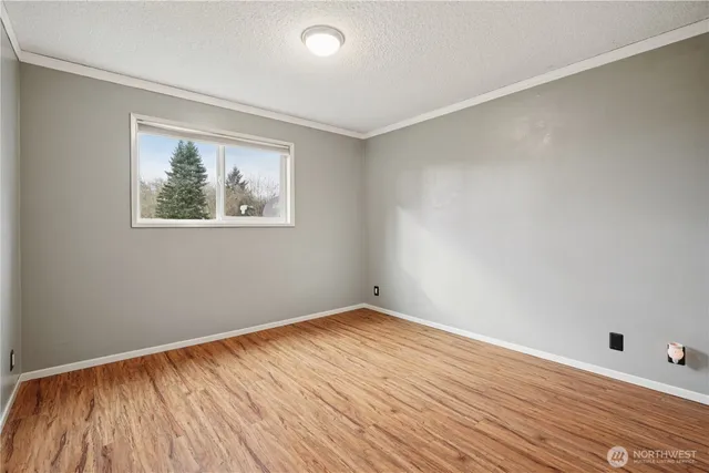 a view of hallway with wooden floor