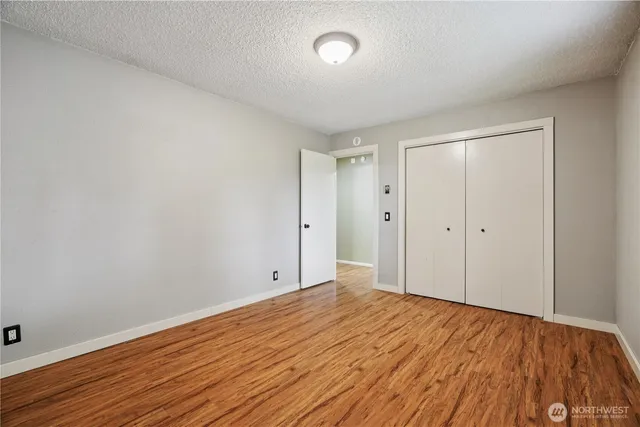 a view of a workspace with furniture and wooden floor