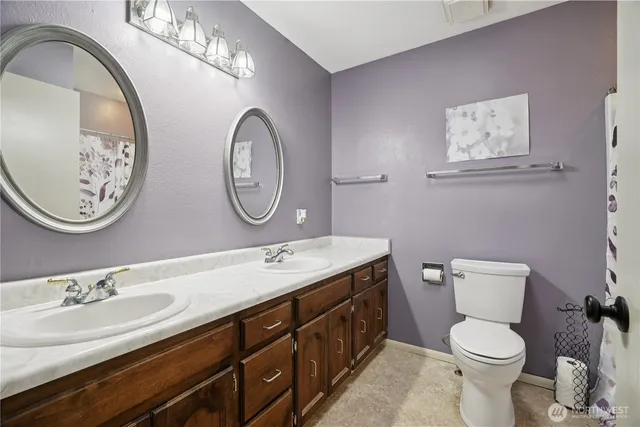 a bathroom with a toilet a sink and a mirror