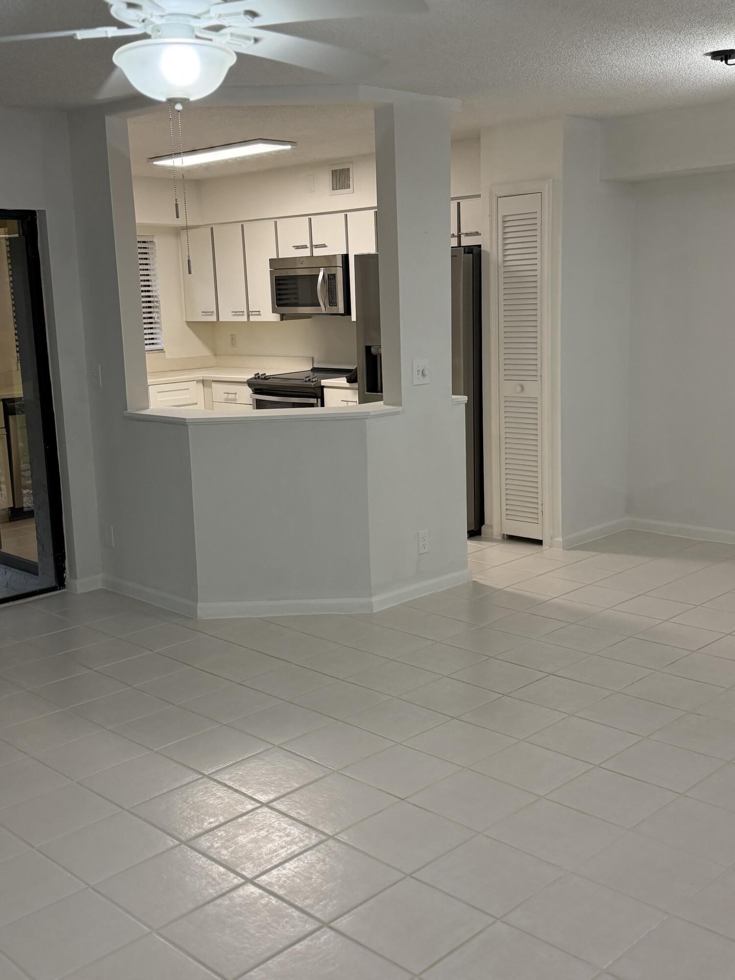 17340 Boca Club Boulevard Boca Raton, FL 33487 - Photo 7 of 24 living room with entrance to kitchen