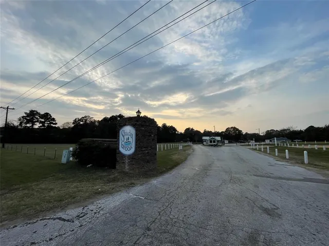 a view of a lake with houses in back
