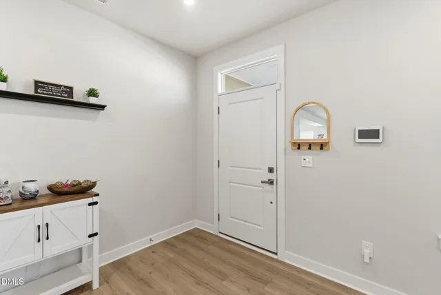 a living room with a fireplace and a flat screen tv
