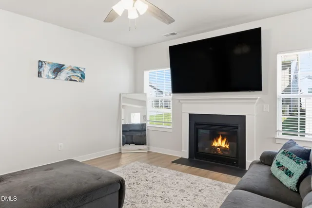 a view of a dining room with furniture wooden floor and a potted plant