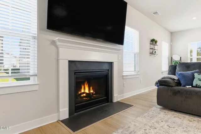 a kitchen with stainless steel appliances granite countertop a white cabinets and wooden floor